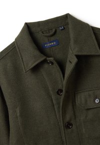 Dark green wool jacket with collar, black buttons, front pocket, and "PIOMBO" label inside the collar.