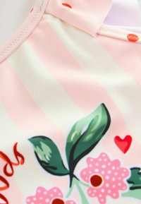 Badeoberteil in Hellrosa mit dünnen vertikalen Streifen. Verfügt über ein florales Design mit grünen Blättern, pinken Blumen und Herzakzenten. Glatte Textur.