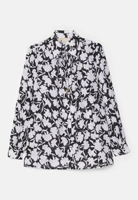 Blusa floral en blanco y negro con mangas largas, cierre de botones en la parte delantera y un detalle de lazo en el cuello. Fabricada en tejido ligero.