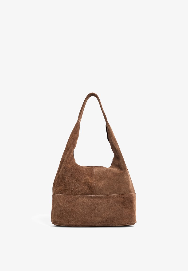 Brown suede hobo bag with a wide, rounded shape, a single shoulder strap, and a flat base. Features a smooth texture and seamless design.
