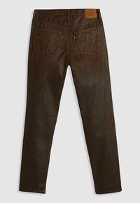 Bruine spijkerbroek met een recht uitgesneden pijp, vijf zakken en een lederen merklabel op de achterste tailleband. Soepele textuur.