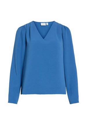 Zils V-veida kakla blūze ar garām piedurknēm, teksturētu audumu un sapulcinātiem plecu akcentiem papildus dimensijai. Parasts piegriezums.