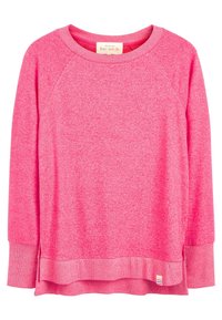 Sweat-shirt en polaire rose avec des manches raglan, un col rond et un ourlet superposé. Présente une petite étiquette rayée en bas à droite.