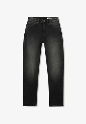 Jean slim noir taille haute avec poches avant, passants de ceinture, fermeture à bouton et légère décoloration au niveau des cuisses et des genoux.