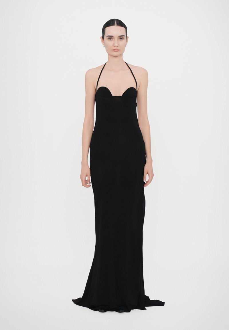 Black floor-length dress with a sleek silhouette, halter neck, curved bodice, and smooth fabric. No visible patterns or hardware details.