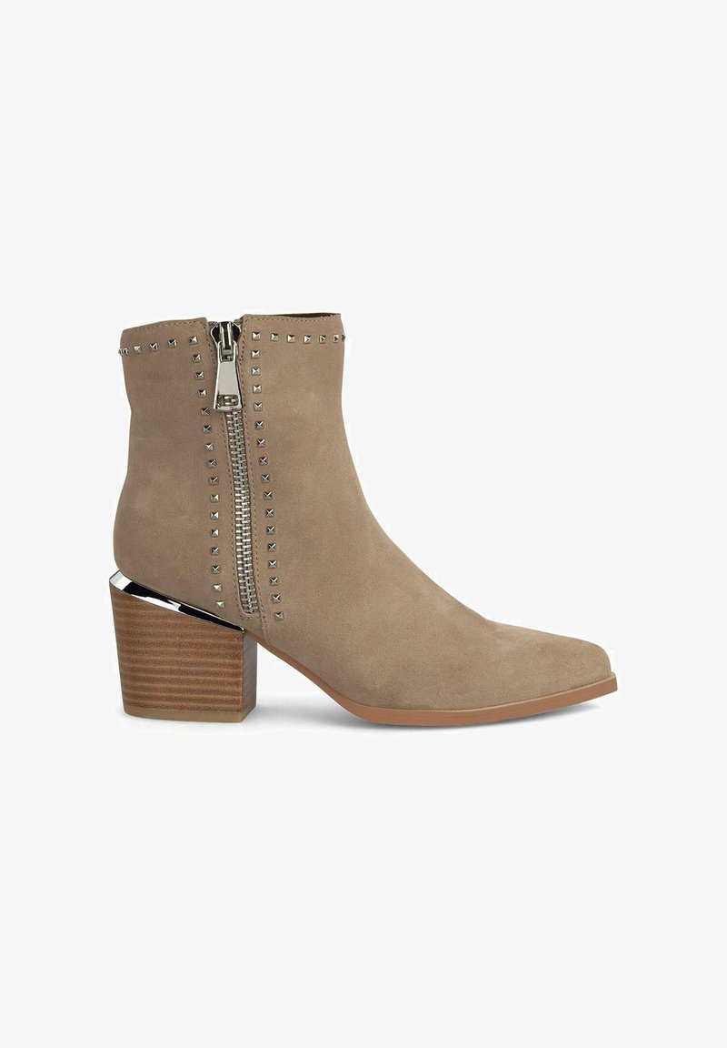 Botín de ante marrón claro con un zipper plateado y detalles de tachuelas, que presenta una puntera cuadrada y un tacón de madera y cromo apilada.