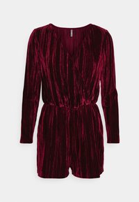 Burgundský sametový overal s dlouhými rukávy, zavinovacím předním dílem, elastickým pasem a svislou proužkovou texturou. Krátká délka nohavic.