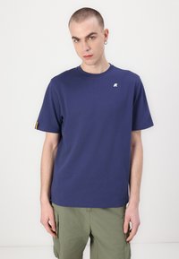 Navy blue cotton t-shirt with a round neckline and short sleeves, featuring a small logo on the chest and a contrasting yellow detail on the sleeve.