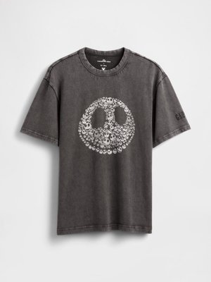 T-shirt grafica grigia in cotone, con un grande disegno circolare di una faccia sorridente con piccoli teschi, maniche corte e scollatura a girocollo.
