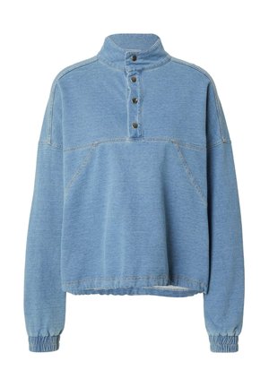 Light blue long-sleeve pullover with high collar and four snap buttons, elastic cuffs, and stitched diagonal seam across the chest.
