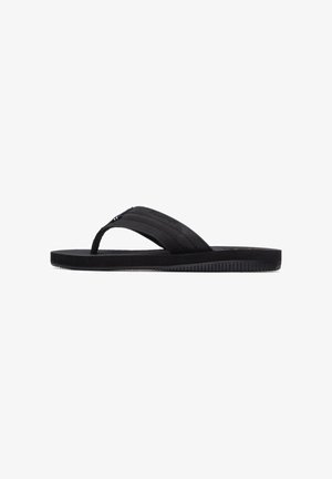 Chancla negra con suela de goma texturizada y un diseño sencillo de dos tiras con acabado liso. Ligera y de perfil plano.