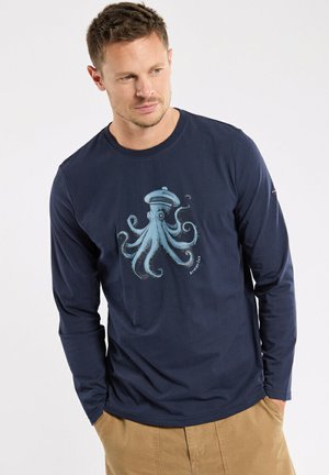 Navy long-sleeve shirt made of cotton with a blue octopus graphic on the front. Features a round neckline and relaxed fit.