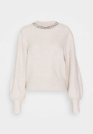 Cremefarbenes Sweatshirt mit geriffelter Textur, langen Ballonärmeln und dekorativem, mit Perlen verziertem Ausschnitt. Strahlt ein weiches, gemütliches Aussehen aus.