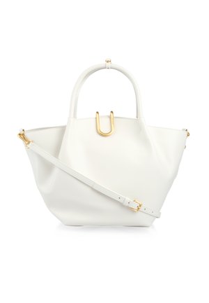 White leather handbag with curved handles, adjustable shoulder strap, and gold U-shaped clasp on front against white background.