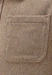 Brown felt fabric featuring a patch pocket with a stitched border, smooth texture, and a subtle heathered pattern.