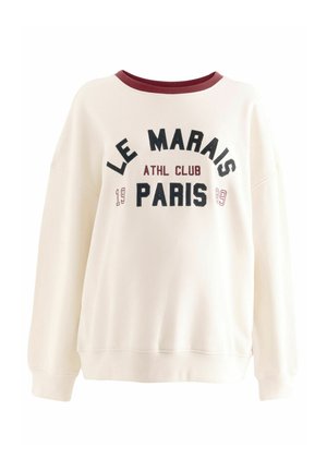 Krémová mikina s burgundským límcem a žebrovanými manžetami. Obsahuje nápis "LE MARAIS ATHL CLUB PARIS" v černém a burgundském písmu. Volný střih.