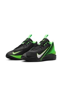 Zwarte en groene Nike-schoenen hebben een gestructureerde bovenkant, een reflecterende zilveren swoosh en een groene rubberen zool met karakteristieke strepen.