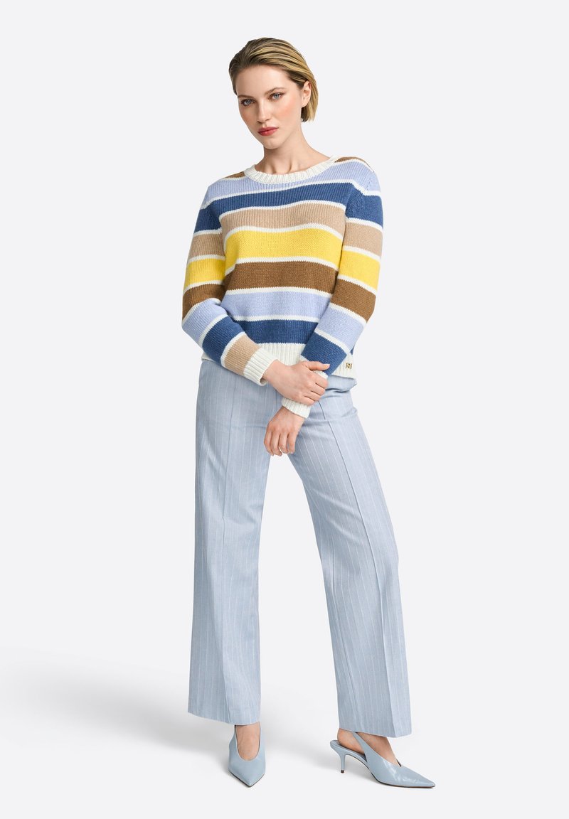 Striped sweater in blue, yellow, and brown with a boat neckline; paired with light blue pinstriped wide-leg trousers and matching heels.