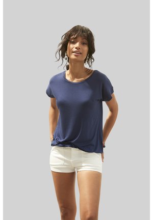 Navy blue short-sleeve t-shirt made from soft fabric with a rounded neckline, paired with white shorts. Simple design, no patterns or graphics.