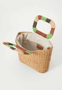 Woven straw bag with a rectangular shape, featuring colorful twisted handles and a beige interior lining with a zippered pocket.