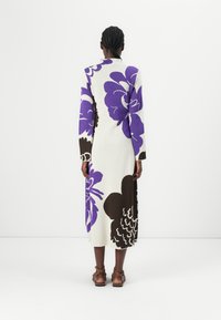 Long-sleeve dress featuring a floral pattern in purple and brown on a white background, with a straight cut and mid-calf length.