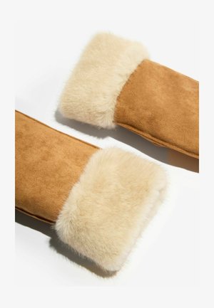 Pruunid seemismaterjalist sõrmikud kreemika kunstkarusnaha mansetiga. Pehme tekstuur, lihtne disain ja tihe istuvus sooja hoidmiseks külmas ilma.