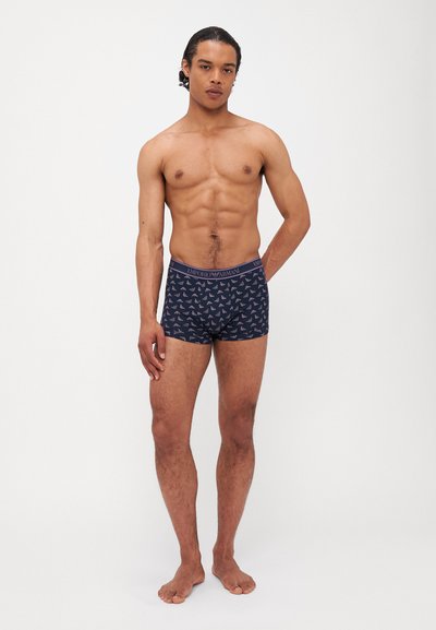 Boxers en jersey navy avec un motif d'oiseaux intégral, présentant une taille de marque. Fabriqués en tissu doux et extensible pour un confort optimal.