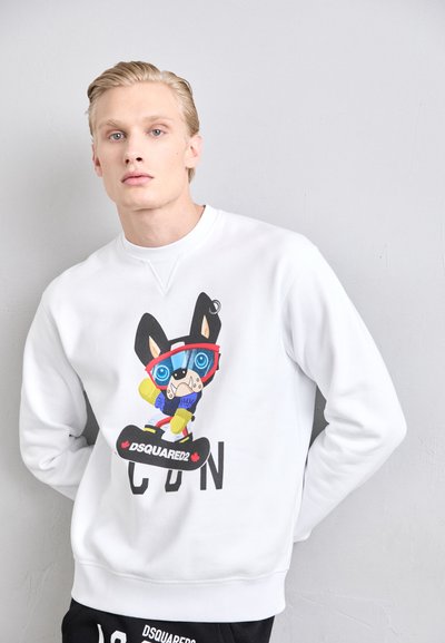 White sweatshirt featuring a cartoon bulldog graphic in blue glasses and winter gear, with the text "DSQUARED2" in bold black underneath.