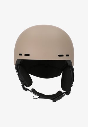 Beige helmet with a rounded shape, matte finish, ventilation holes, and adjustable chin strap. Interior features padded ear covers.