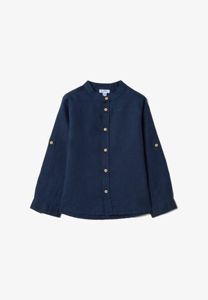 Chemise bleu marine à manches longues avec des boutons en bois sur le devant et aux manches, présentant un col mao et des poignets boutonnés.