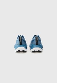 Blue athletic shoes with a light mesh upper, white sole, and contrasting black heel accent. Features padded collar and textured design.