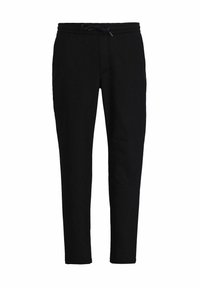 Svarta joggingsbyxor i mjukt material, med elastisk midja och snörning, smalnande ben och minimalistisk design.