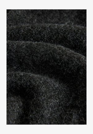 Melna vilna audums ar mīkstu, teksturētu virsmu. Materiāls rāda smalkas šķiedras, radot nedaudz pūkainu izskatu ar dabiskām variācijām.