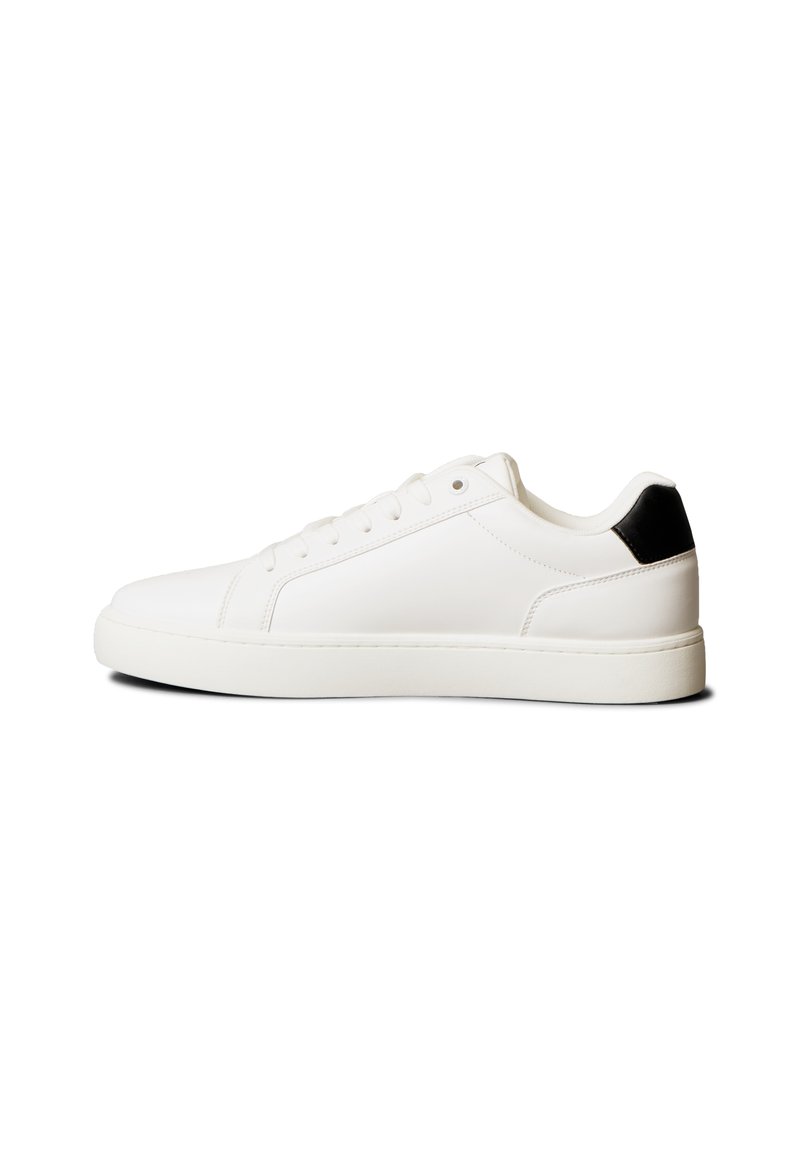 White leather sneaker with a smooth finish, lace-up design, rounded toe, and a contrasting black heel accent. Rubber sole provides grip.