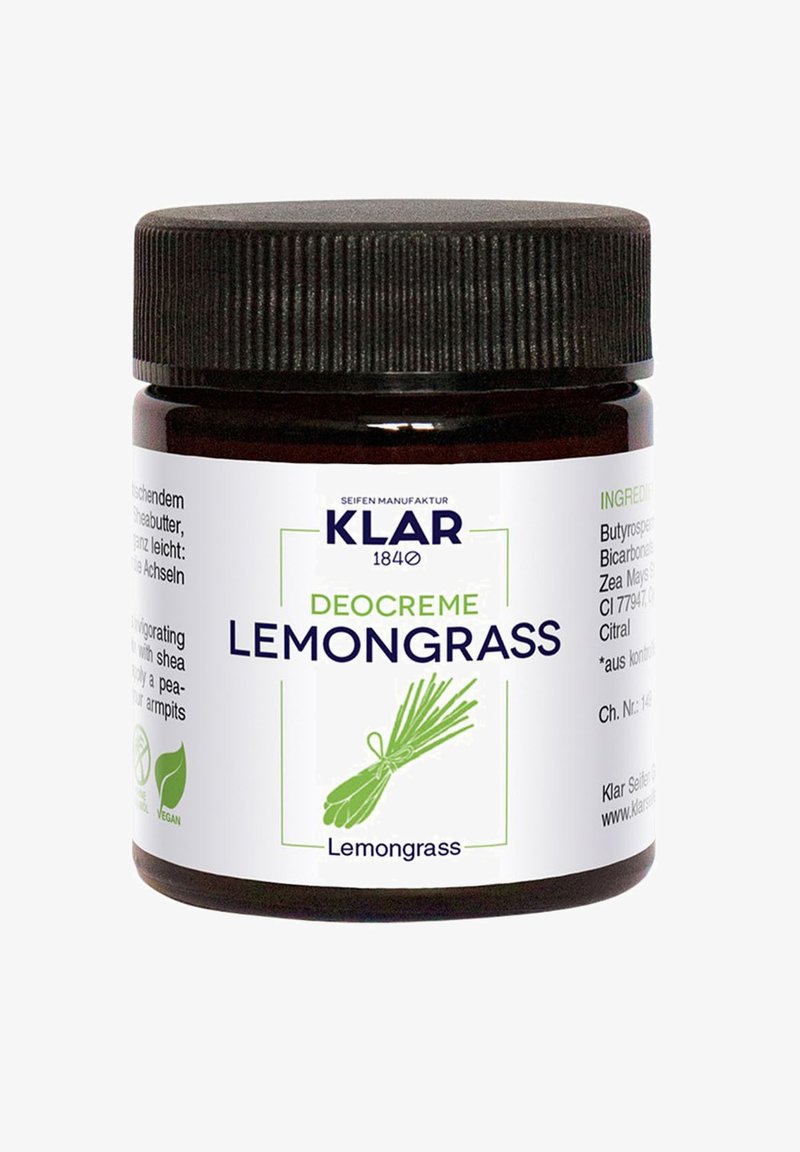 Dark brown glass jar with a black ribbed lid. Label features green text stating "Deocreme Lemongrass," botanical illustration, and ingredient details.