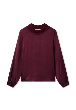 Top lungo bordeaux con collo alto a coste spesse, texture liscia e polsini arricciati. Design semplice e aderente con un colore uniforme.