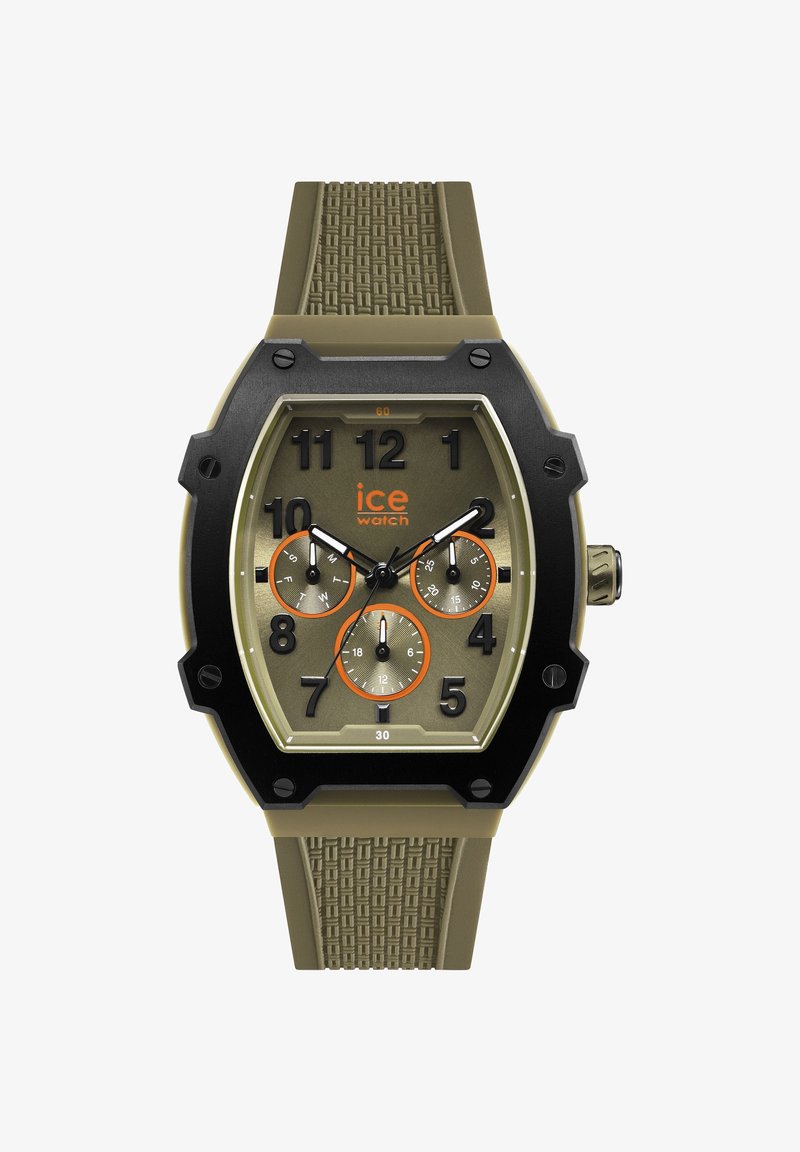 Khaki ja musta käekell, millel on tekstuuriga rihm, suured araabia numbrid, kolm aladiialku ja oranžid aktsendid kellamehhanismi näol.