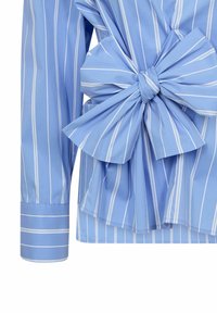 Light blue striped shirt with a bow detail at the waist, featuring long sleeves and a smooth, woven fabric texture.