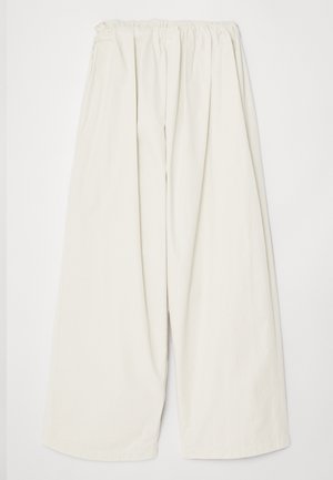 Licht beige wijde broek van katoen, voorzien van een elastische tailleband en een zachte textuur met subtiele plooien en geen zichtbare zakken.