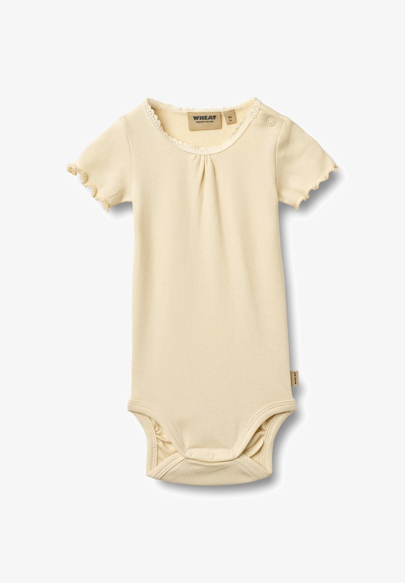 Body bébé à manches courtes en côtelette de couleur crème douce. Doté d'une bordure festonnée et de fermetures à pression à l'épaule et à l'entrejambe.