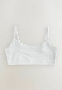 Bralette bianco in cotone con spalline regolabili, finitura in pizzo lungo la scollatura e un piccolo fiocco al centro davanti. Tessuto morbido e elasticizzato.