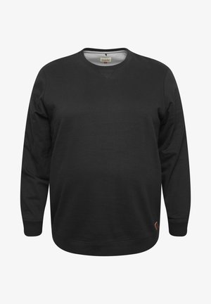 Melna džemperis ar garām piedurknēm, apaļu kaklu un mīkstu tekstūru. Uz apakšējās malas ir neliela logo birka. Vienkāršs dizains, nav rakstu.