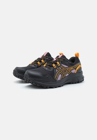 Black athletic shoes feature mesh upper with orange and pink accents, sturdy laces, a textured sole, and a cushioned heel for support.