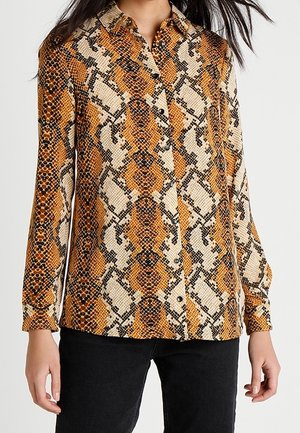 Hemd mit Knöpfen, das ein Schlangendruckmuster in Orange, Schwarz und Creme zeigt. Lange Ärmel, Kragen und strukturiertes Material.