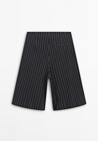 Shorts tailleur à rayures noires, dotés d'une seule poche arrière et d'une texture lisse. Des rayures de couleur claire contrastent avec le tissu.