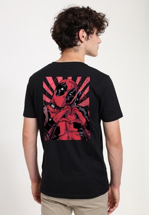 Black T-shirt featuring a colorful Deadpool graphic on the back. The design shows Deadpool making a heart shape with his hands, set against red rays.