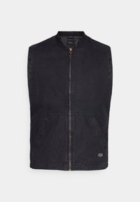 Czarna bezrękawnik z wysokim kołnierzem, złotym zapięciem na zamek i dwiema przednimi kieszeniami. Wykonany z trwałego materiału o chropowatej powierzchni.