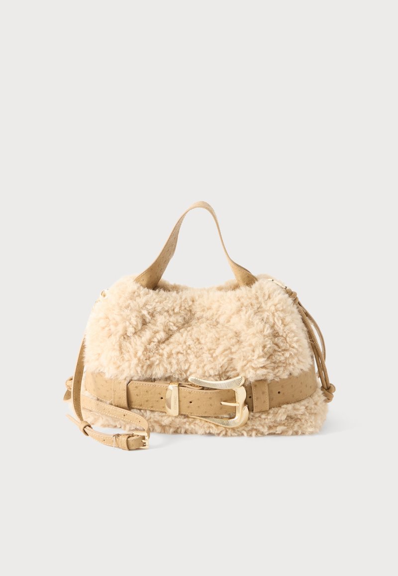 Petit sac à main beige avec texture duveteuse, doté d'une large ceinture avec une boucle dorée et d'une courte poignée sur le dessus, sur fond uni.