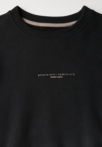 Sort sweatshirt med rund hals, prydet med trykte koordinater og teksten "STREET SIGNS" i en kontrasterende lys farve. Blødt materiale.