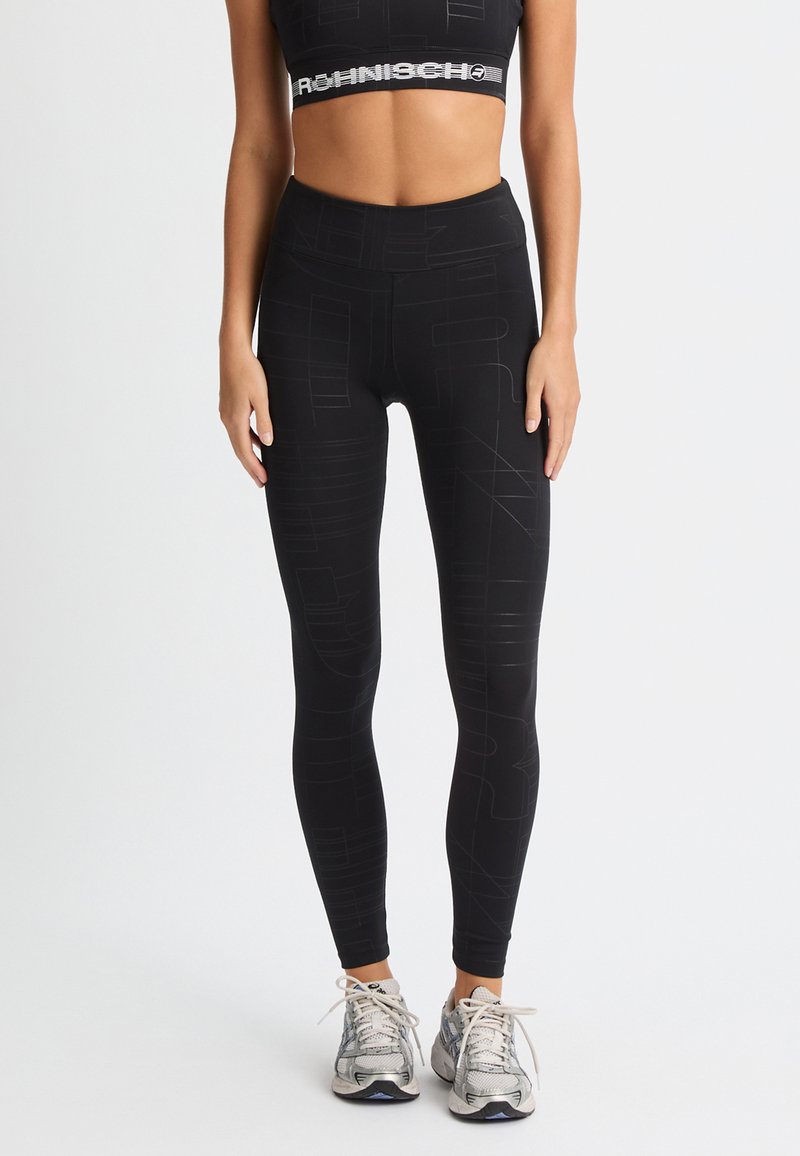 Leggings da allenamento neri con motivi astratti, vita alta e texture liscia, abbinati a un reggiseno sportivo cropped coordinato.
